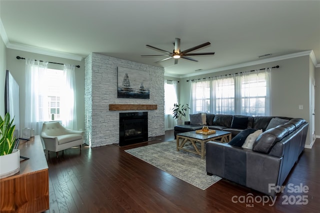246 Sweet Briar Dr, Fort Mill, SC 29707 - living room featuring a stone fireplace, crown molding, a ceiling fan, and dark wood-style flooring