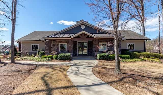 246 Sweet Briar Dr, Fort Mill, SC 29707 - craftsman-style home with stone siding, covered porch, french doors, and a shingled roof
