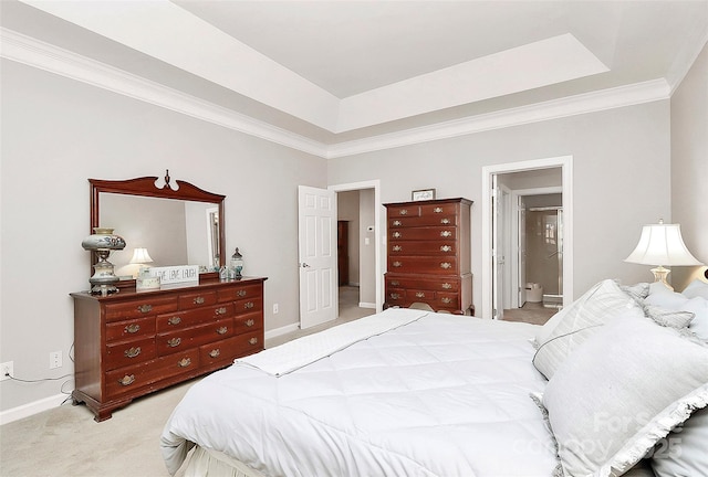 bedroom featuring a raised ceiling, light colored carpet, baseboards, and ornamental molding