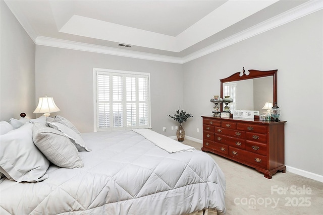 bedroom featuring visible vents, crown molding, baseboards, light colored carpet, and a raised ceiling