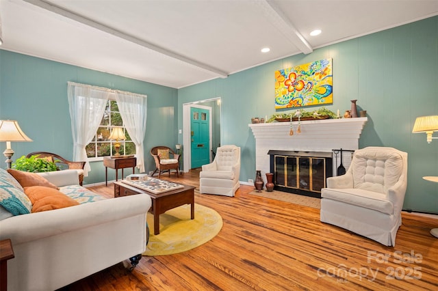 living room featuring baseboards, beam ceiling, recessed lighting, a fireplace, and wood finished floors