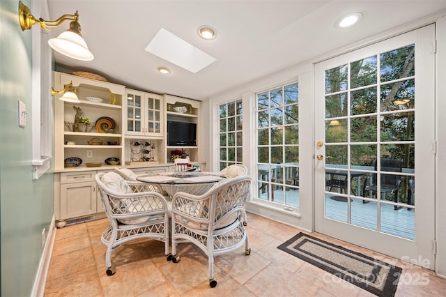 dining room featuring recessed lighting and a skylight