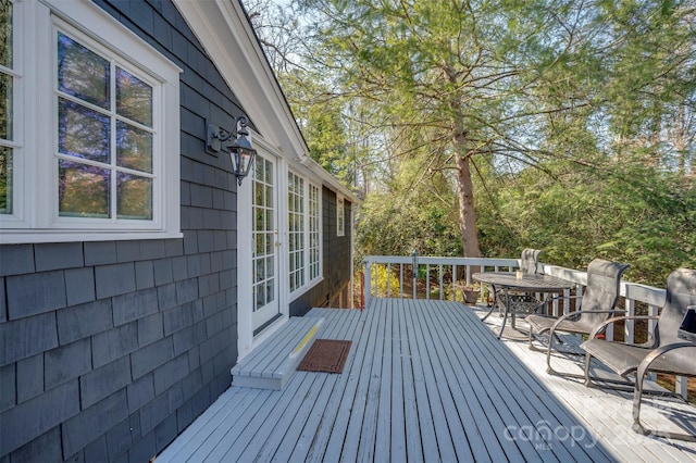 deck featuring outdoor dining space and french doors