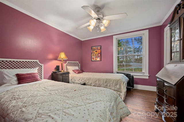 bedroom with a ceiling fan, crown molding, wood finished floors, and baseboards