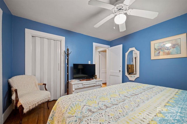 bedroom featuring a closet, dark wood-type flooring, and ceiling fan