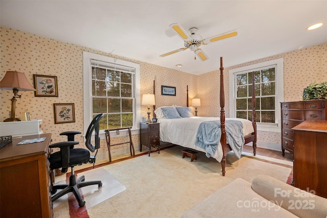 bedroom with ceiling fan and wallpapered walls