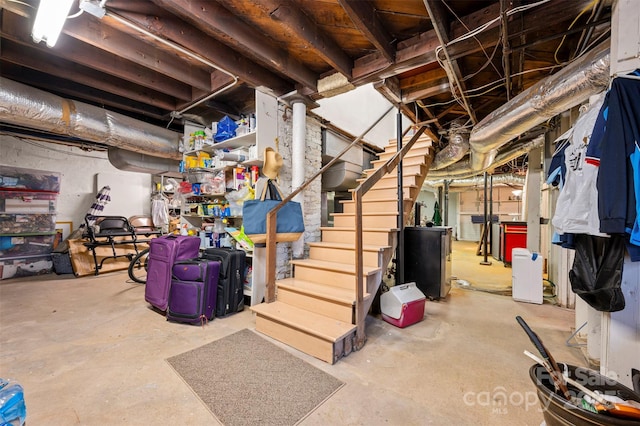 unfinished basement featuring stairs