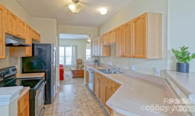 kitchen featuring under cabinet range hood, light brown cabinetry, light countertops, stainless steel appliances, and a sink