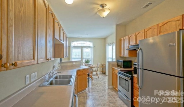 kitchen with visible vents, under cabinet range hood, a sink, appliances with stainless steel finishes, and light countertops