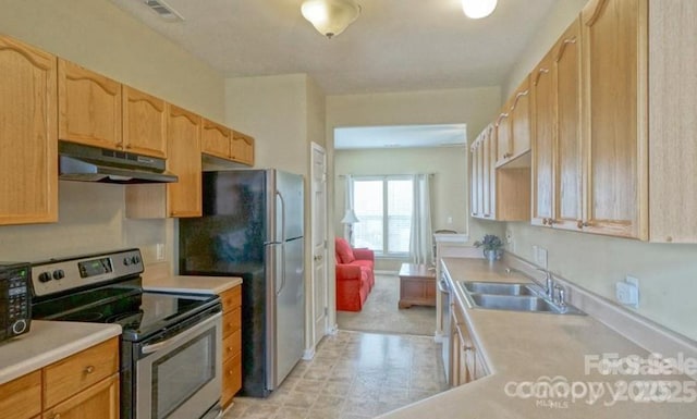 kitchen featuring visible vents, under cabinet range hood, light countertops, stainless steel appliances, and a sink