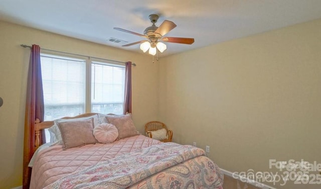 bedroom with visible vents, baseboards, and ceiling fan