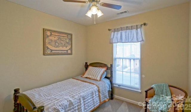 carpeted bedroom featuring visible vents, a ceiling fan, and baseboards