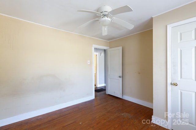 unfurnished room featuring baseboards, wood finished floors, ceiling fan, and crown molding