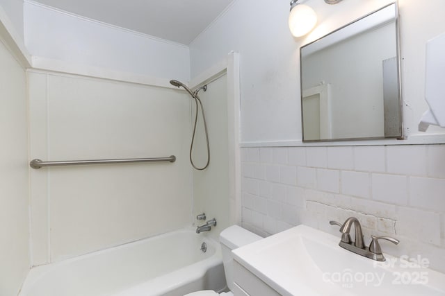 full bathroom with tile walls, toilet, ornamental molding, bathtub / shower combination, and vanity