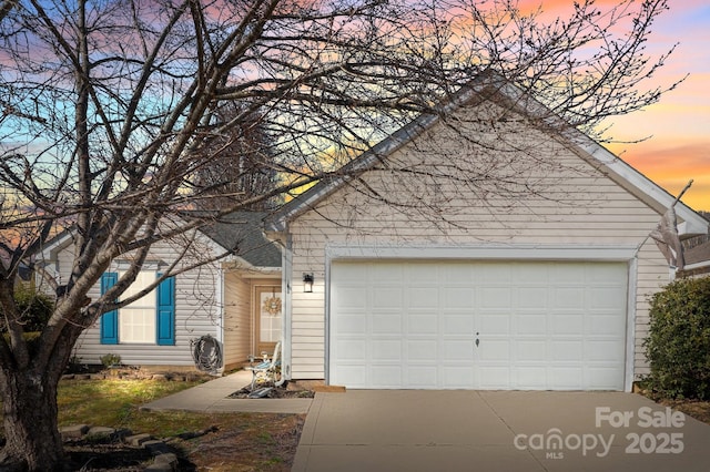 view of front of property featuring an attached garage and concrete driveway