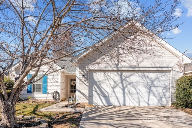 view of front facade with concrete driveway and an attached garage