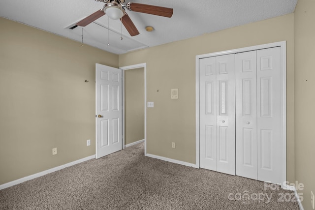 unfurnished bedroom with baseboards, a closet, carpet floors, and ceiling fan