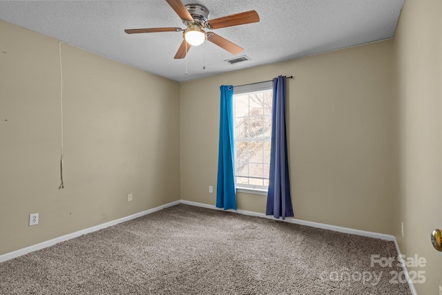 carpeted empty room featuring visible vents, baseboards, a textured ceiling, and a ceiling fan