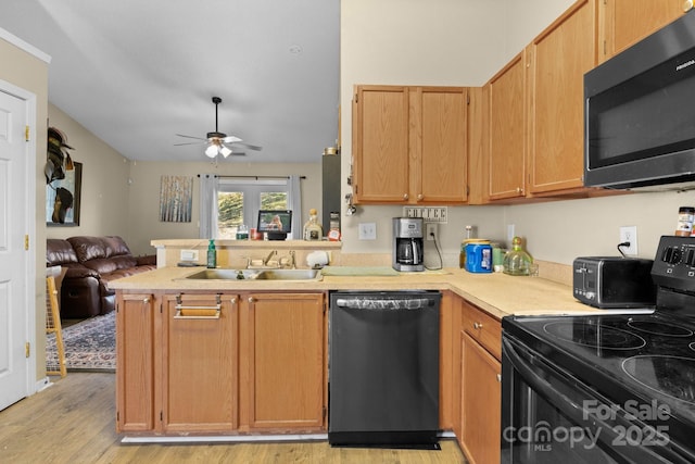 kitchen featuring a sink, black range with electric cooktop, dishwasher, stainless steel microwave, and open floor plan