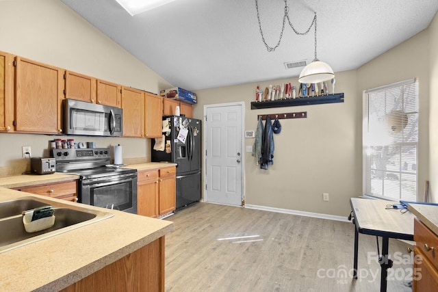 kitchen featuring a wealth of natural light, visible vents, appliances with stainless steel finishes, and vaulted ceiling