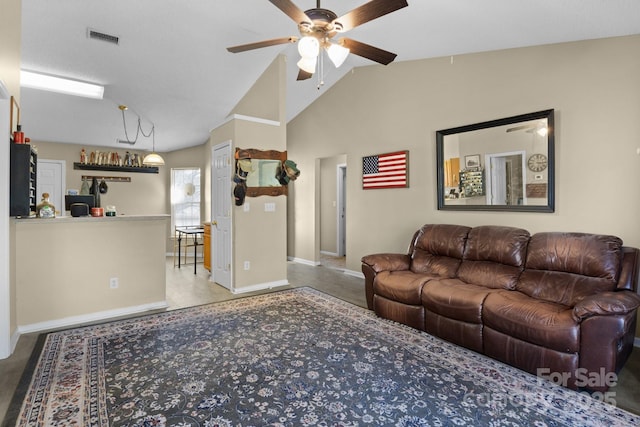 living room featuring visible vents, baseboards, a ceiling fan, and vaulted ceiling