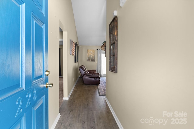 hall with wood finished floors and baseboards