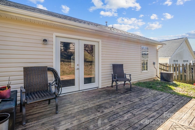 deck with central air condition unit, fence, and french doors