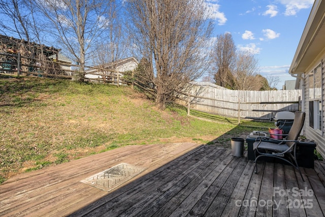 deck with a yard and fence