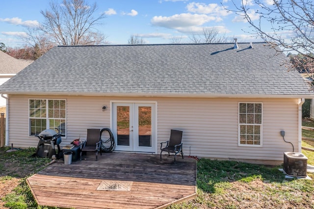 rear view of property featuring a shingled roof, french doors, central AC, and a wooden deck