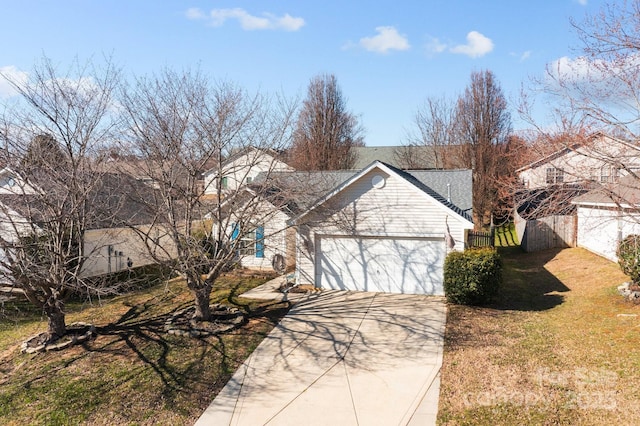 single story home with an attached garage, concrete driveway, a front yard, and fence