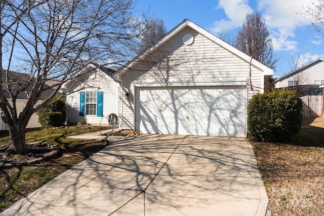 ranch-style house featuring concrete driveway, fence, and a garage