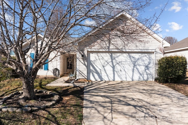 view of front of house with concrete driveway and a garage