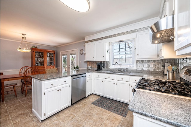 kitchen featuring a peninsula, a sink, stainless steel appliances, white cabinets, and exhaust hood