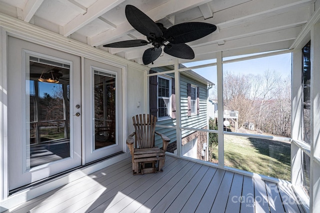 unfurnished sunroom with a wealth of natural light and a ceiling fan