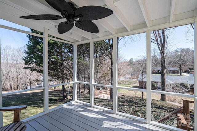 unfurnished sunroom with a ceiling fan