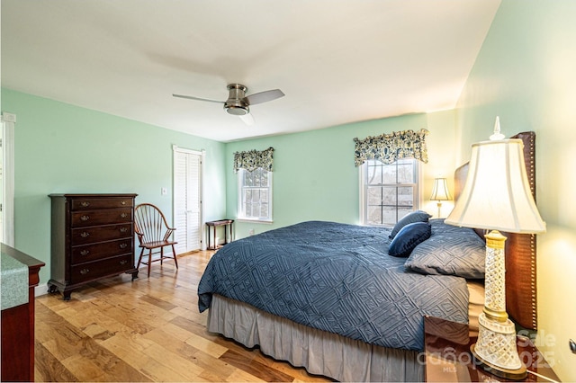 bedroom featuring a closet, wood finished floors, and a ceiling fan