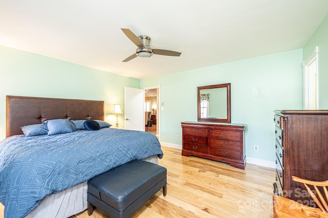 bedroom with baseboards, light wood-style floors, and a ceiling fan