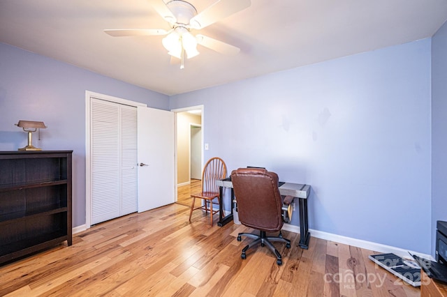 office with ceiling fan, baseboards, and wood finished floors