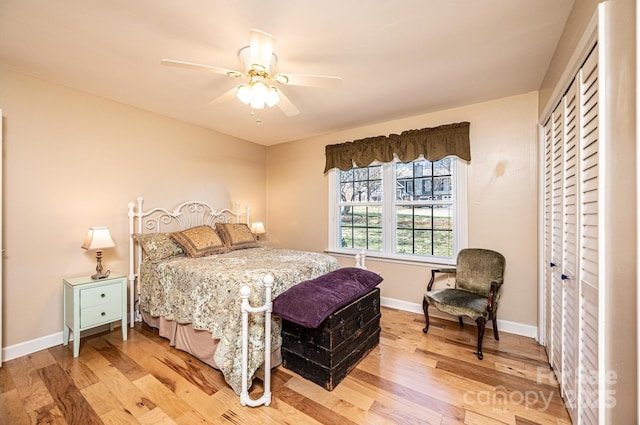 bedroom featuring light wood-style floors, baseboards, and ceiling fan