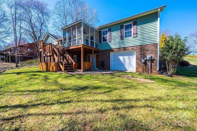 rear view of house with stairway, an attached garage, a yard, a sunroom, and brick siding