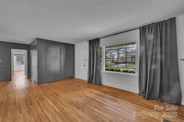 unfurnished bedroom featuring baseboards and light wood-style floors