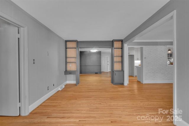 interior space featuring light wood-type flooring and brick wall