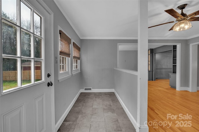 doorway with a ceiling fan, visible vents, a wealth of natural light, and ornamental molding