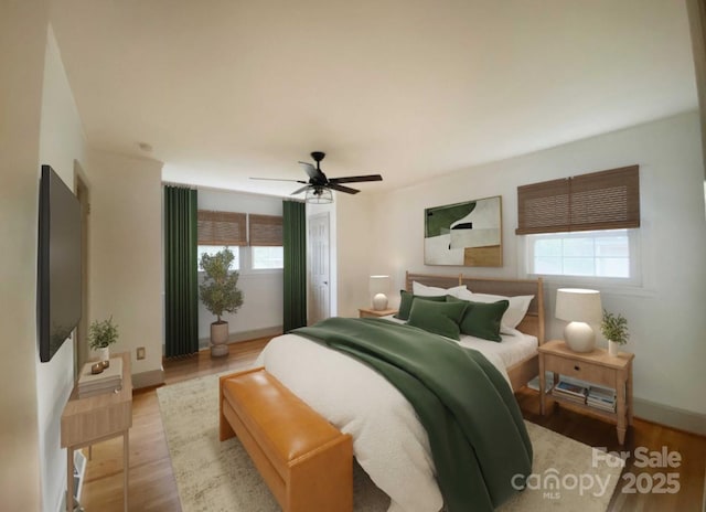 bedroom featuring ceiling fan, baseboards, and wood finished floors