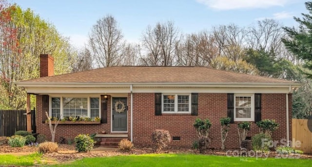 view of front of house with brick siding, a chimney, and fence