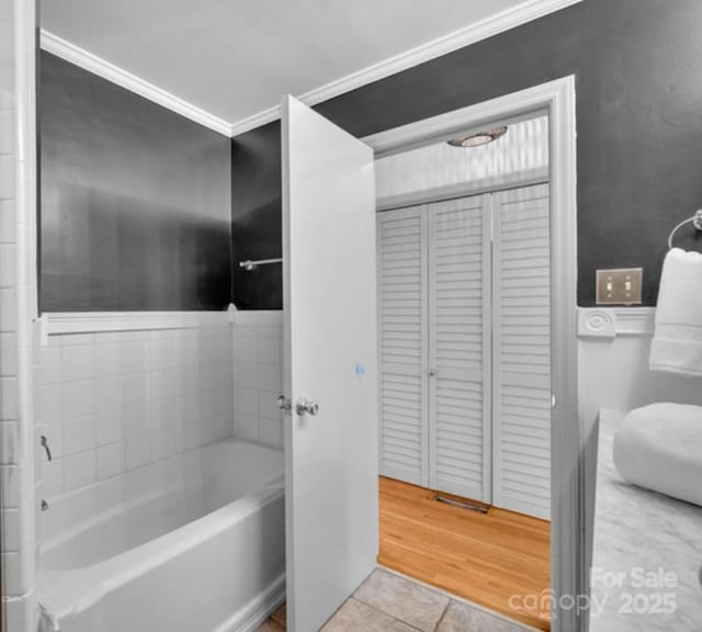 full bath with tile patterned flooring, a washtub, and ornamental molding