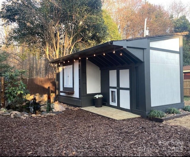 view of outbuilding with an outbuilding and fence