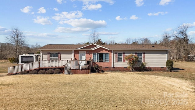 view of front of property with crawl space, a deck, a front lawn, and roof with shingles