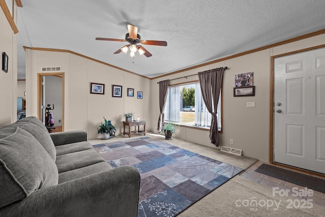 carpeted living room with visible vents, a textured ceiling, ceiling fan, and crown molding