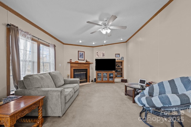 living area featuring a fireplace with flush hearth, light carpet, a ceiling fan, and crown molding